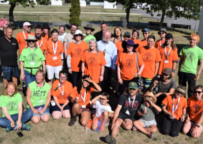 Photo of large group of people wearing orange or green t-shirts featuring the HEFF slogan