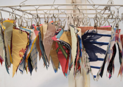 Rows of handmade bunting hanging on a drying rack