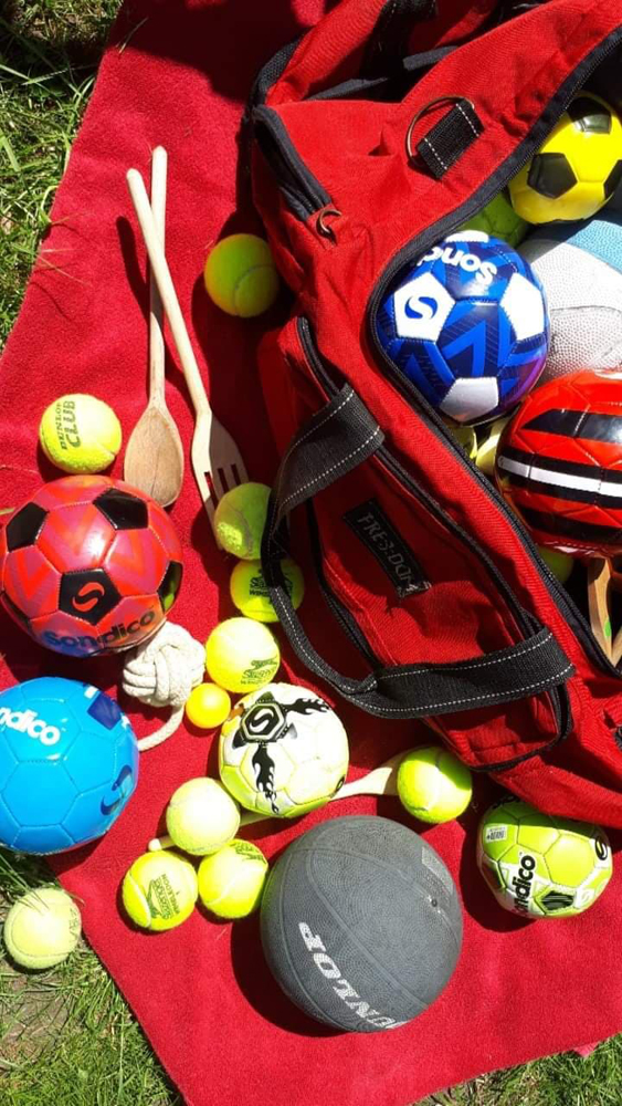 Close up photo of a red bag filled with juggling equipment