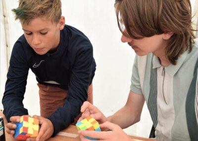 Photo of two young people playing with Rubik's Cubes