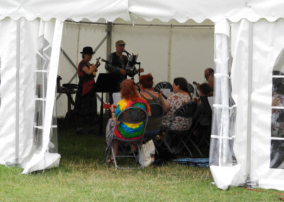 Photo of a group of people in a marque learning the ukelele