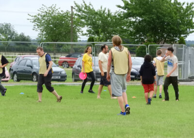 Photo of a group of people outside playing frisbee