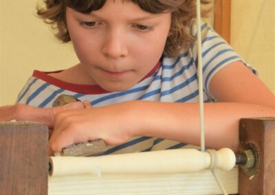 Photo of a young person concentrating hard while woodturning