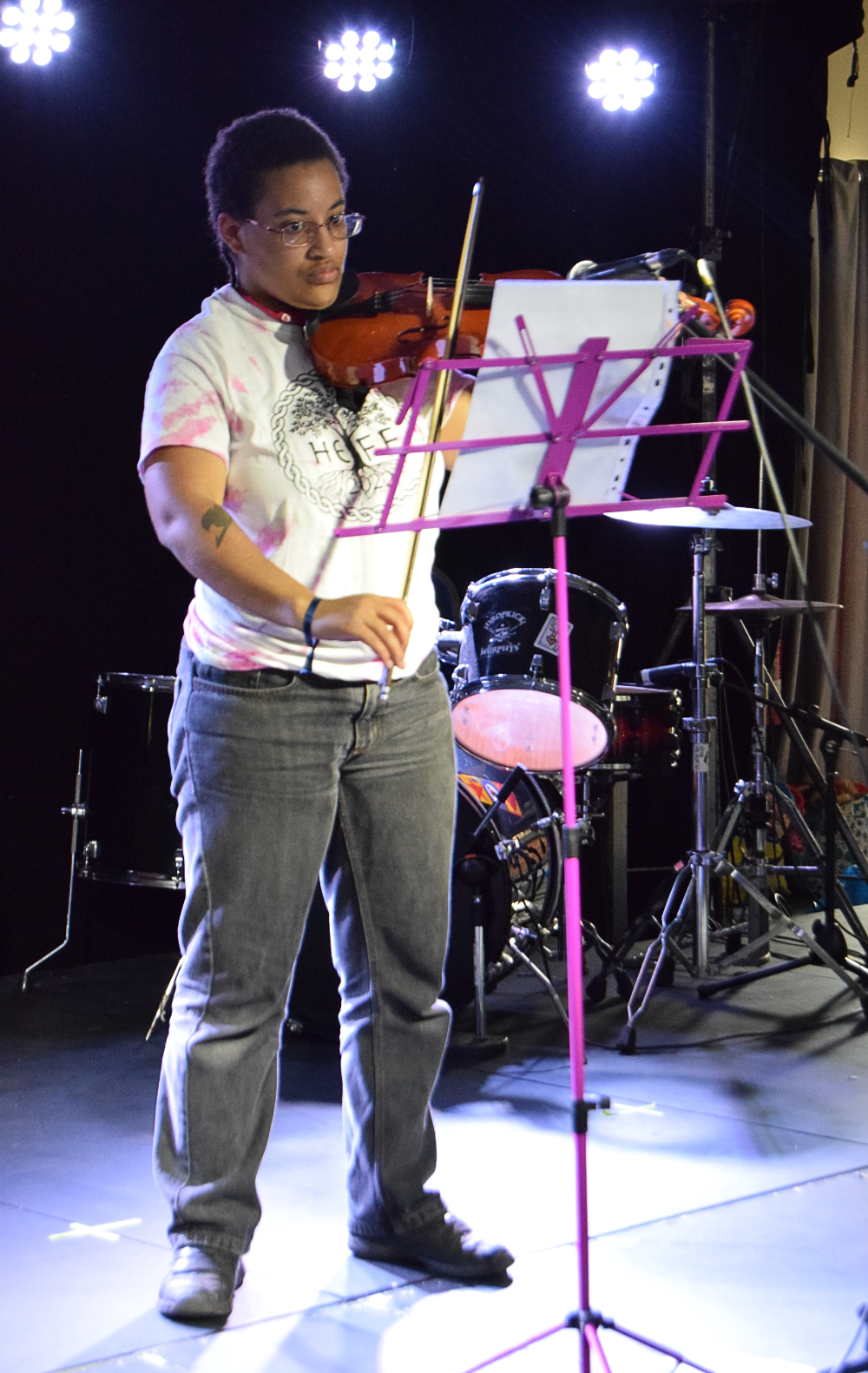 Photo of a young person playing the violin on stage